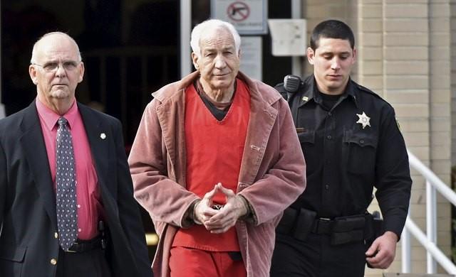 Picture: Former Penn State assistant coach Jerry Sandusky hauled away in handcuffs