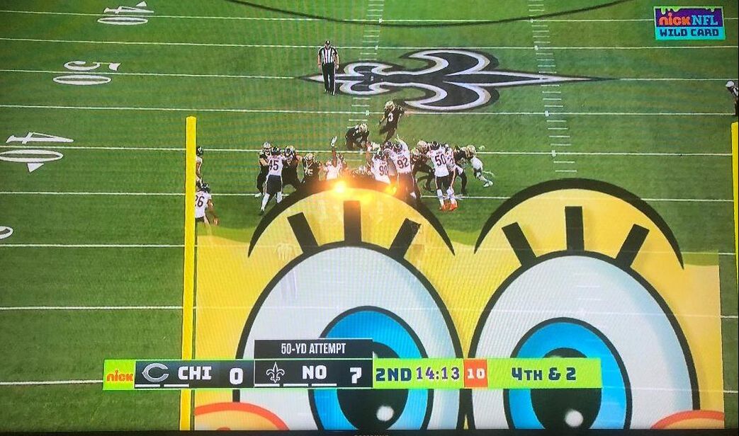 Picture: Saint kicker Will Lutz attempts field goal with giant SpongeBob graphic looking on