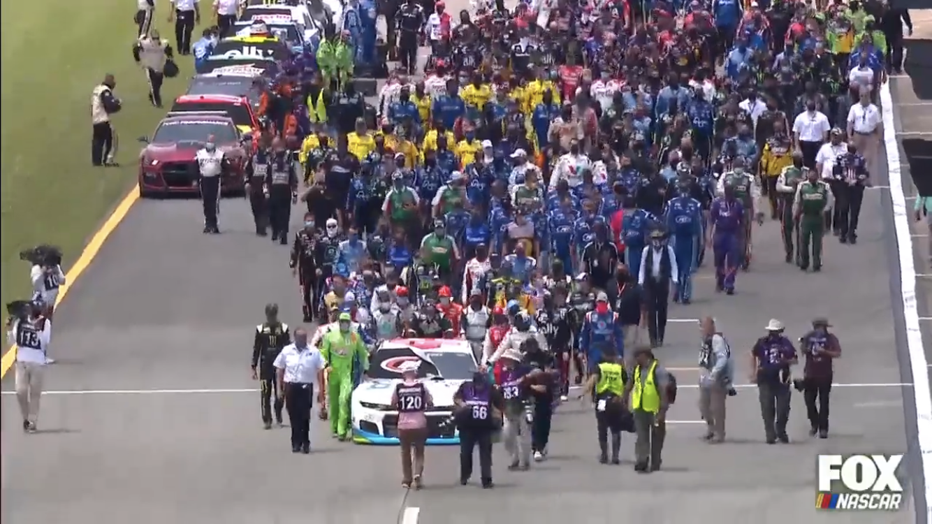 Picture: Bubba Wallace's fellow competitors help push his 43 car to front of the grid before Monday's Talladega race in show of unity